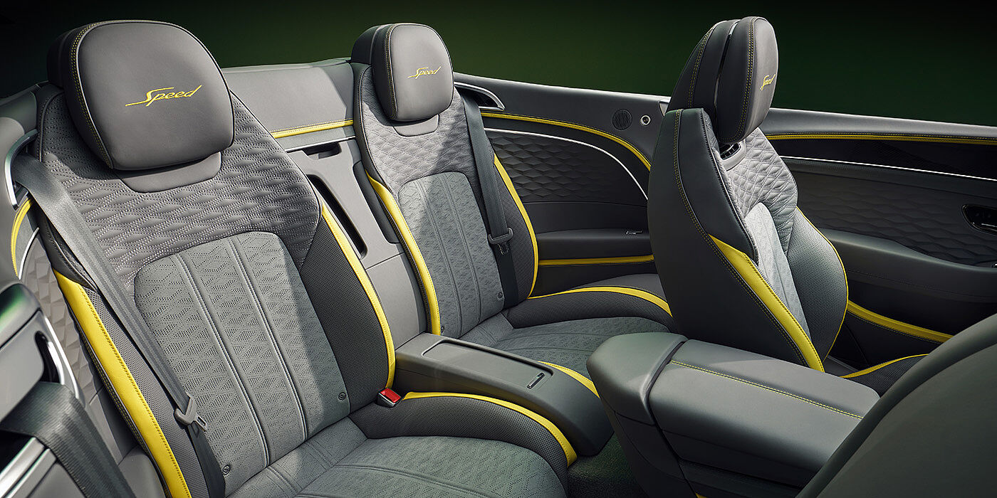 Bentley Yerevan Bentley New Continental GTC Speed convertible rear interior with unique Speed colour split in Gravity Grey and Cyber Yellow hide colours, and contrast stitched headrest emblems 