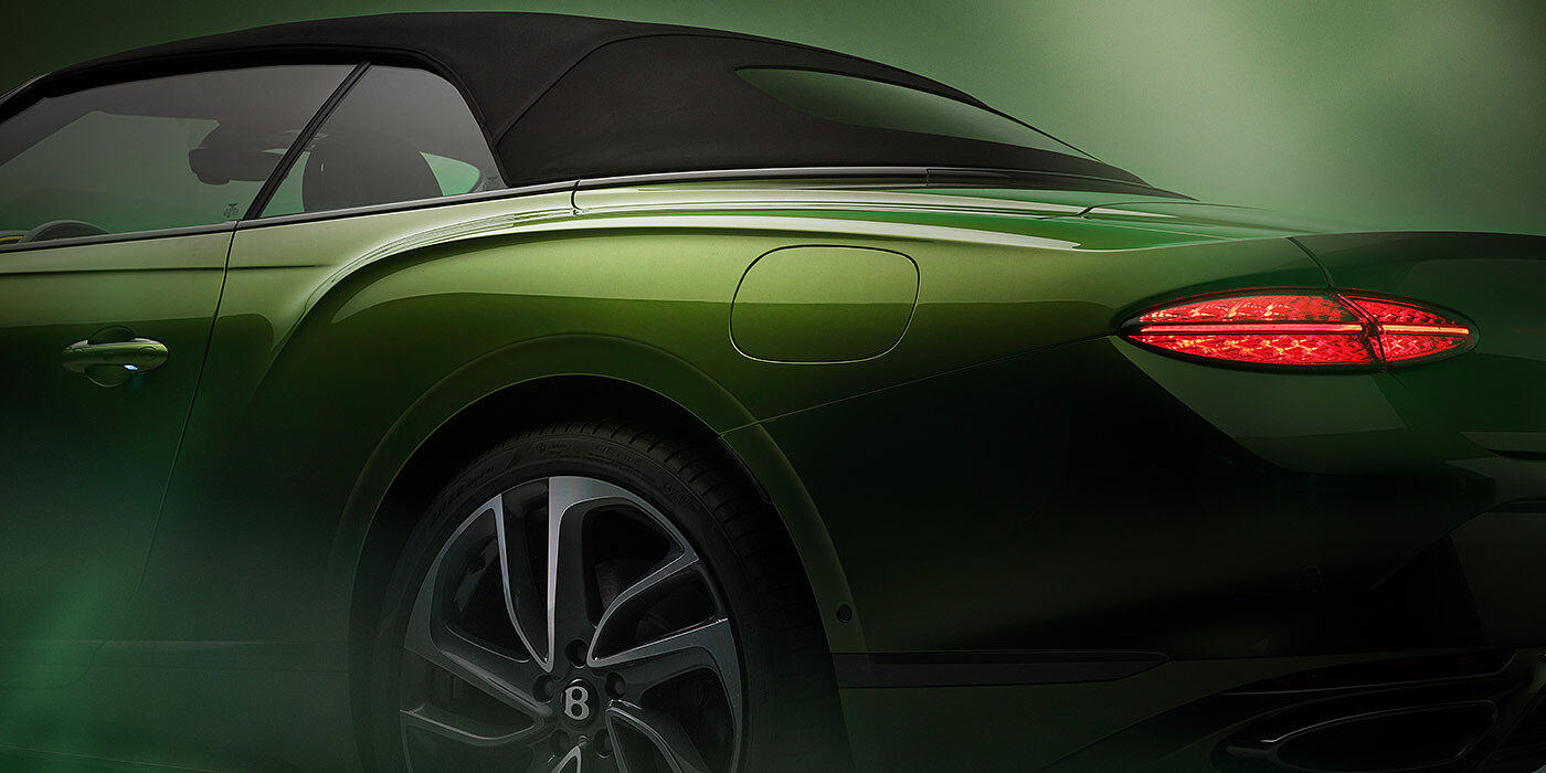 Bentley Yerevan Bentley New Continental GTC Speed rear haunch and tail lamp in Tourmaline Green paint and dark tint brightware with black hood up and illuminated head lamps